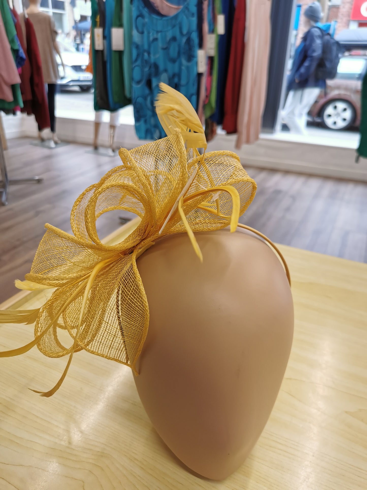 fascinator on a satin covered alice band with feathers.