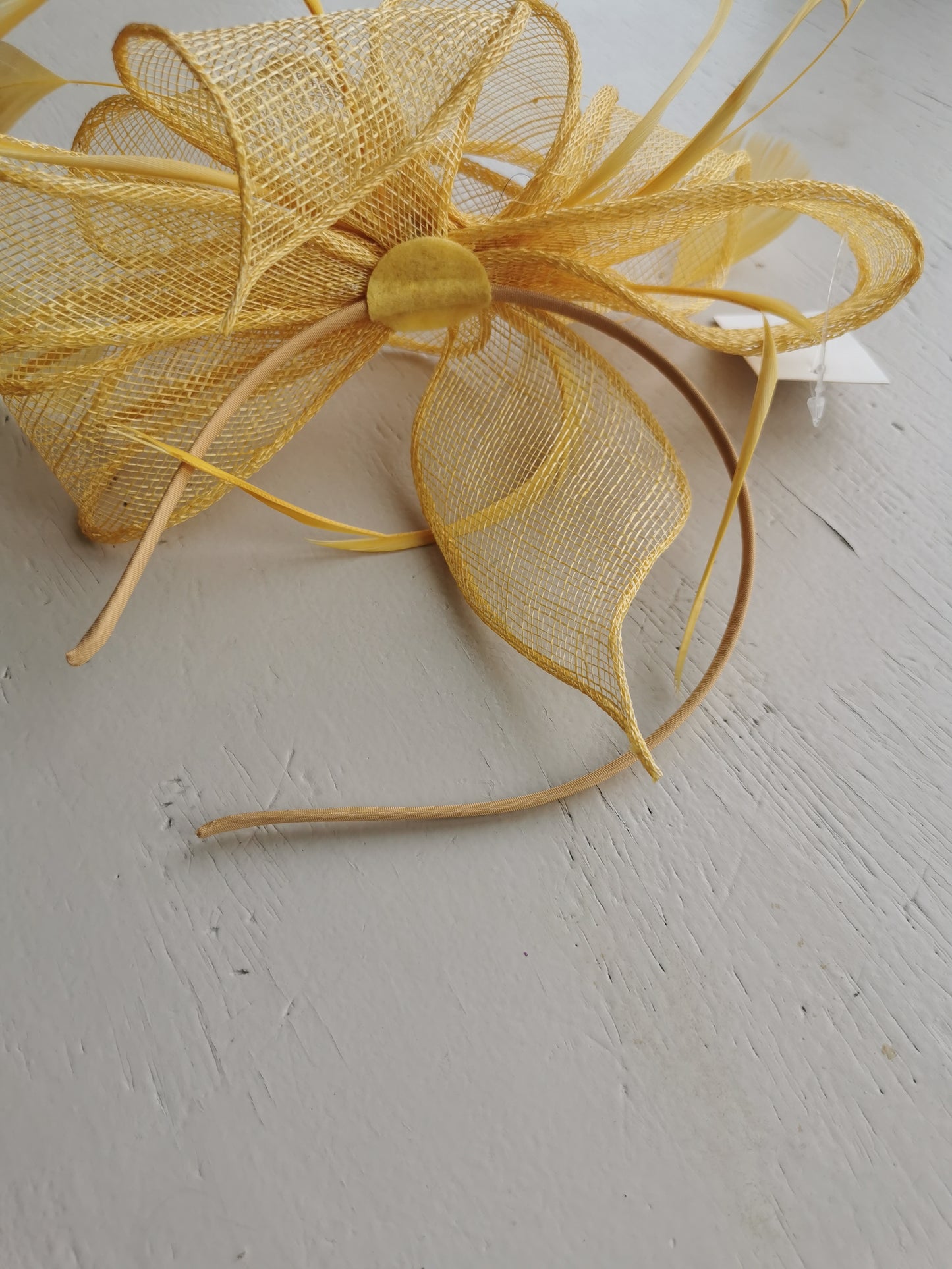 fascinator on a satin covered alice band with feathers.