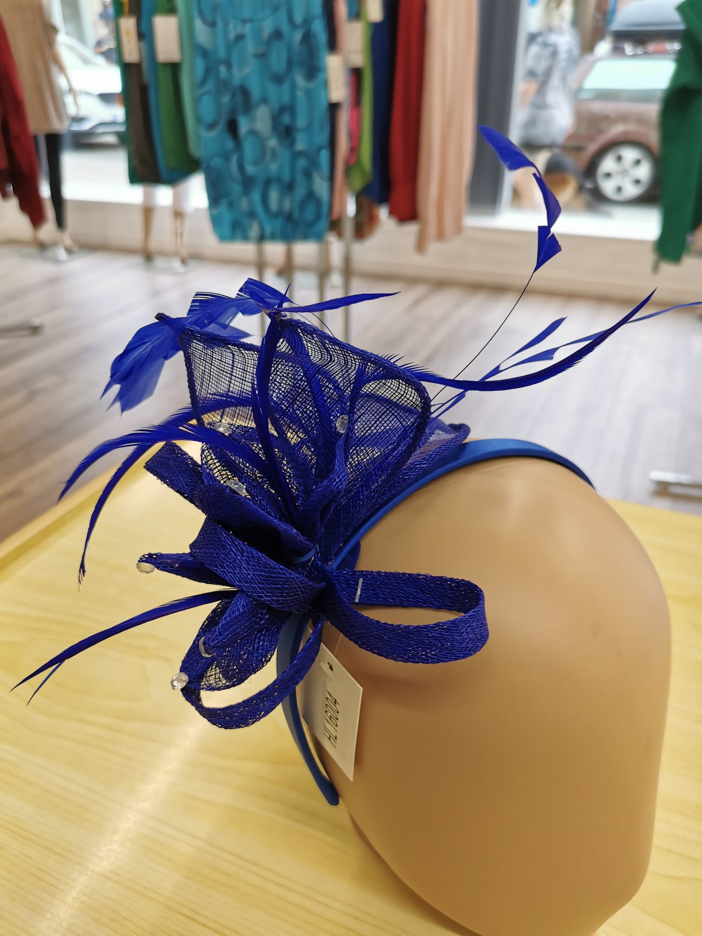 Flower Fascinator on a Satin Alice band with feathers and Clear acrylic stones