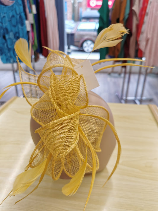 fascinator on a satin covered alice band with feathers.